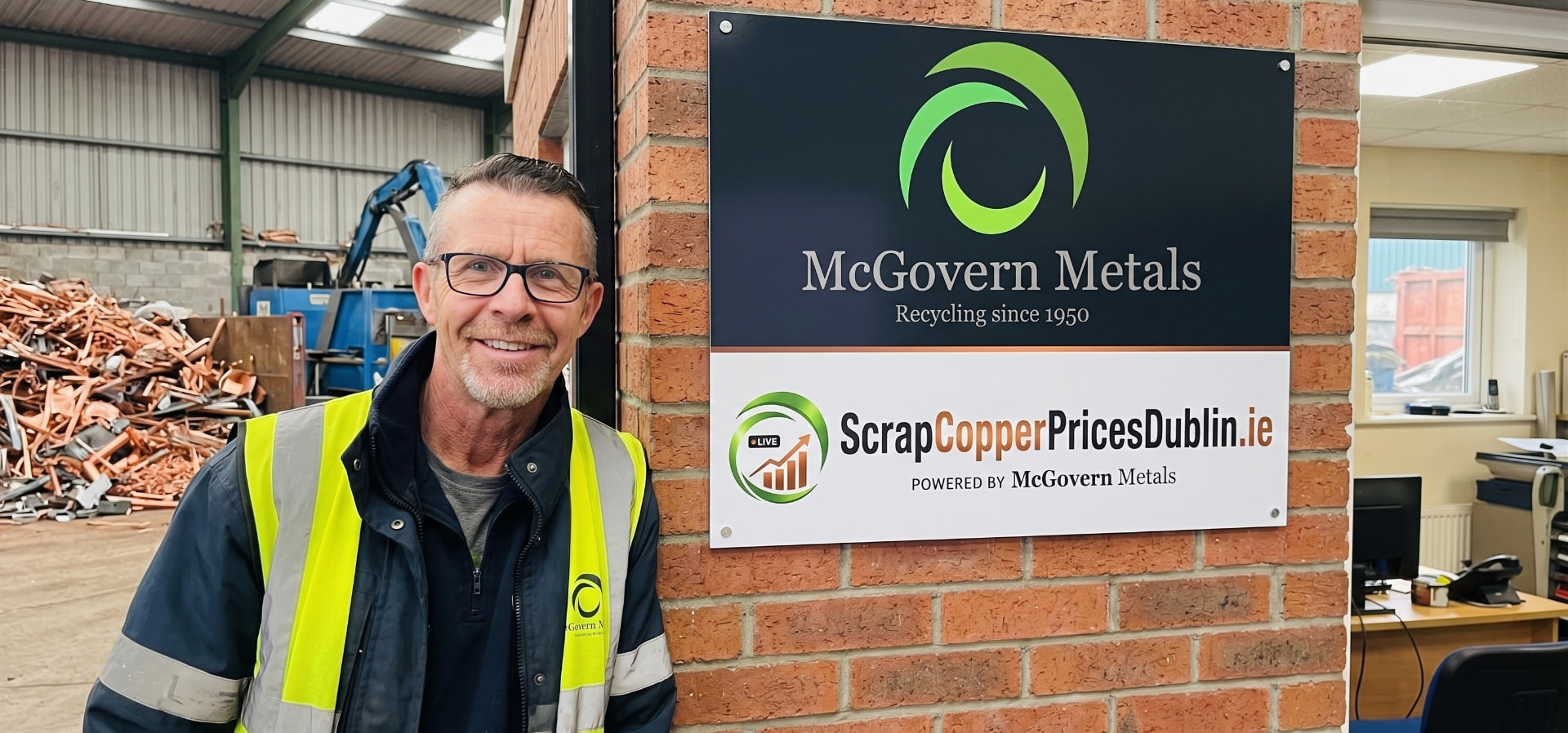 Keith Stewart O'Brien, Yard Manager at McGovern Metals, beside the ScrapCopperPricesDublin.ie sign at the yard in Dublin